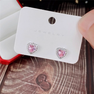 Close-up of heart-shaped pink zircon stud earrings with white micro-diamond halo