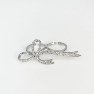 Detailed close-up of a silver bow ring with shimmering rhinestones and adjustable band