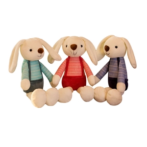 Three plush long-eared rabbits in striped overalls on a clean white background