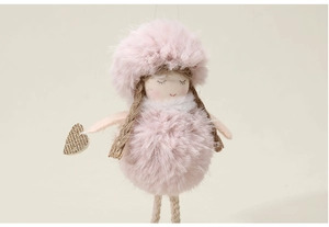 Close-up of pink plush angel doll ornament with heart detail and soft fiber texture