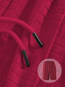 Macro shot of red waffle texture fabric and drawstring detail on casual men's shorts