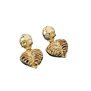 Golden skeleton heart drop earrings with colorful zircon stones on white background