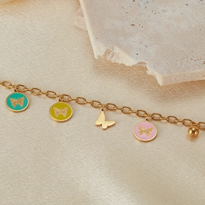 Detail of a gold stainless steel chain bracelet with colorful butterfly enamel charms