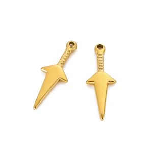 Detailed close-up of two golden kunai-shaped stainless steel charms with polished finish