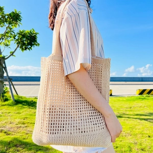 Minimalist beige crochet tote bag for women showing a hollow woven design for outdoor use