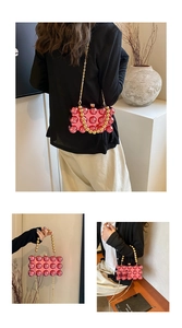 Pink bubble acrylic egg-shaped handbag featuring gold chain and beaded texture