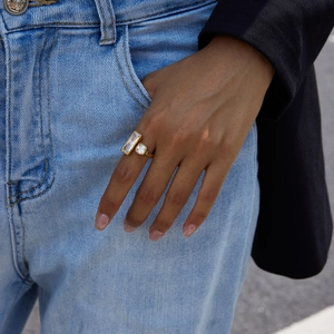 Minimalist 18K gold-plated stainless steel ring with two cubic zirconia on a model's hand