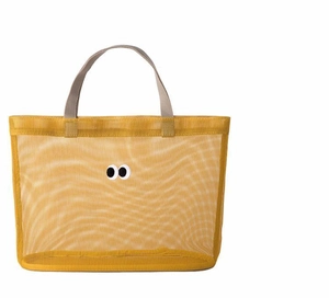 Detailed close-up of yellow mesh tote bag with iconic cartoon eye design on white background