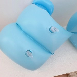 Detail of blue inflatable arm bands with dual safety valves for children's swimming