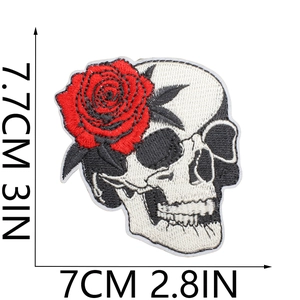 Detailed view of skull and rose embroidered patch with size markings 7.7cm by 7cm