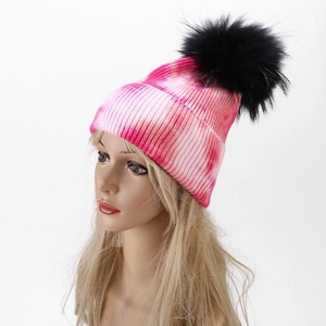 Pink and white tie-dye knit beanie with large black faux fur pom pom for women