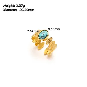 Detailed macro view of gold titanium steel floral ring with turquoise stone and wheat band