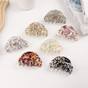 Large acetate hair claws in various vintage patterns including leopard and floral prints