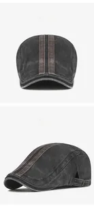 Close-up of vintage washed newsboy hat with brown leather straps and metal buckle