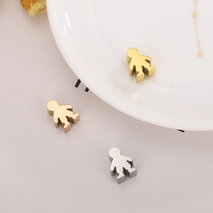 Detailed view of gold and silver boy and girl cartoon charms for DIY jewelry making