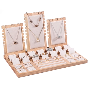 Multi-tier wooden jewelry display set with beige velvet lining for necklaces and rings