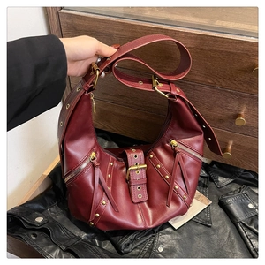 Vintage burgundy hobo shoulder bag with silver eyelets and rivets on black leather