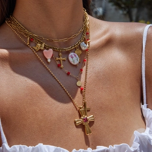 Layered 18K gold stainless steel necklace with heart cross and pearl charms on model