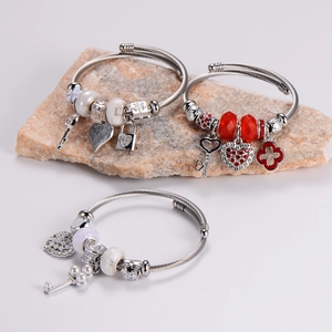 Silver beaded bracelet with heart, key, lock pendants and pearls on natural stones