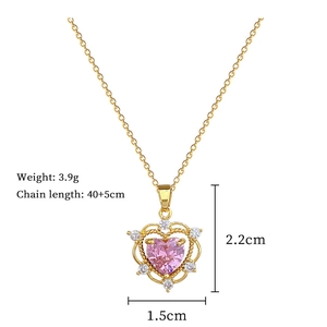 Close-up of gold heart pendant necklace with pink gem and white crystals 3.9g weight