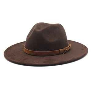 Close-up of a dark brown suede cowboy hat featuring a decorative strap and metal buckle