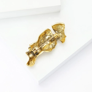 Detailed back view of golden alloy mask brooch showing secure pin and clasp structure