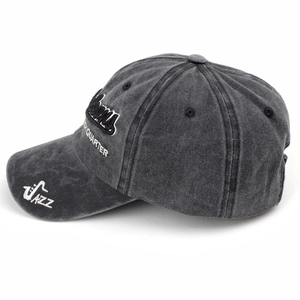 Detail of gray washed cotton baseball cap with white JAZZ and QUARTER embroidery