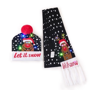 Detail of LED glowing Christmas hat and scarf set with Let It Snow text on black knitwear