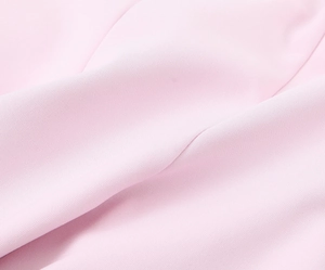 Macro shot of soft pink elastic fabric showing smooth texture and high-quality fine grain
