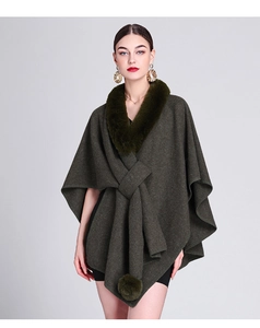 Detail of dark green knit shawl with faux rabbit fur collar and decorative pom-poms