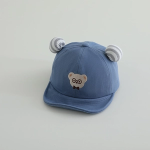 Detail of baby sun hat featuring embroidered bear and 3D ears on soft cotton fabric