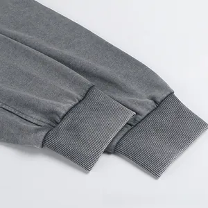 Detail of ribbed cuffs on oversized dark gray cotton sweatshirt with vintage washed texture