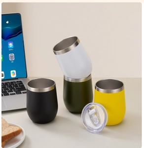 Detail of four colorful 12oz vacuum insulated egg cups with clear lids in a home office set