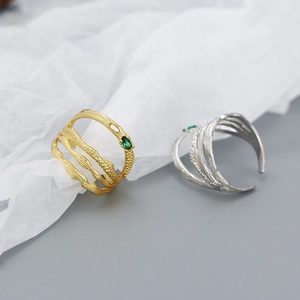 Detailed macro view of irregular double-layered silver ring with green marquise gemstone