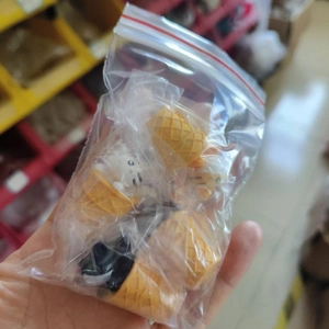 Close-up of cute ice cream cat miniature figurines inside a clear plastic packaging bag