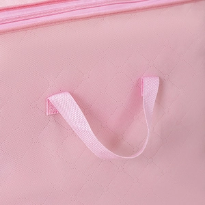 Detailed close-up of pink storage bag showing reinforced handle and woven fabric texture