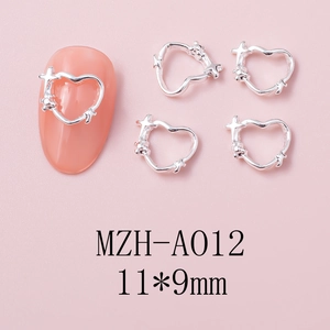 Detailed view of silver heart nail charms with cross and star patterns, size 11x9mm