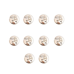 Close-up of ten rose gold round alloy pendants with Joys & Wise embossed text on white background