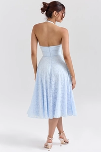 Detailed back view of a light blue halter dress with lace texture and backless design