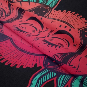 Macro detail of Bohemian tapestry showing fabric texture and vibrant sun demon print