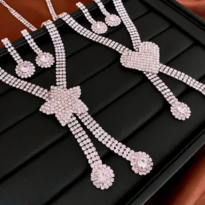 Exaggerated heart and star pendant necklace set with rhinestone earrings in silver tone