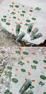 Macro view of 3D goldfish and lotus leaf nail stickers with realistic water drops