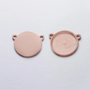 Macro detail of rose gold stainless steel round bezel pendant for jewelry making