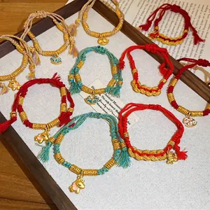 Handwoven red rope bracelets with gold charms and horse pendants for prosperity