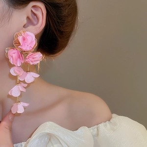Detail of pink chiffon floral tassel earrings featuring long hanging fabric petals
