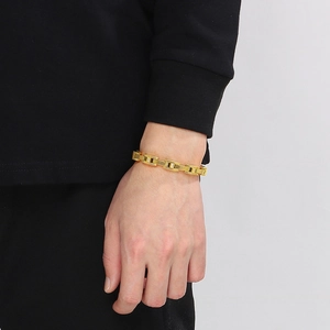 Macro shot of gold watchband style men's bracelet with cubic zirconia inlays