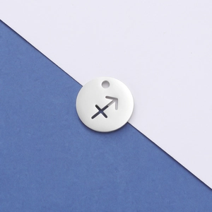 Macro detail of silver stainless steel Sagittarius constellation cutout charm pendant