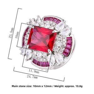 Macro view of a large rectangular red gemstone ring with floral diamond halo detailing