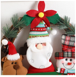 Close-up of fabric Christmas wreath characters including Santa, reindeer and snowman