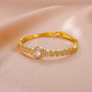 Vintage gold heart-shaped bangle with center crystal and pave rhinestones for women